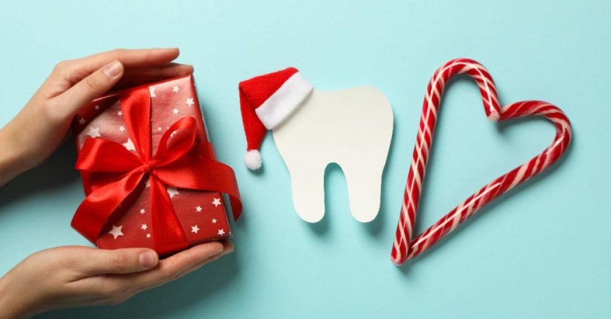 Teeth with Christmas accessories around, flat lay. Teeth with Christmas accessories around, flat lay.